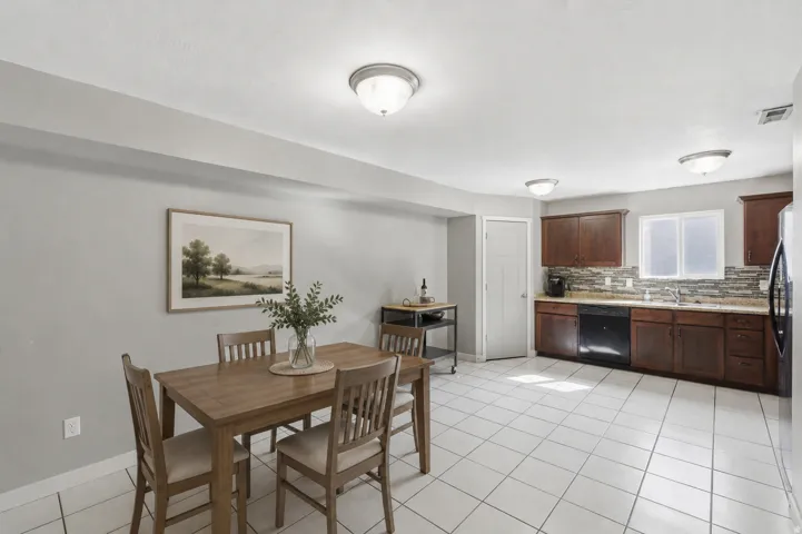 Open-concept kitchen and dining area featuring ceramic tile flooring