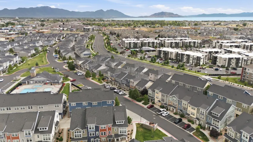 Aerial overview of a residential development featuring varied housing styles including townhomes and multi-story apartment buildings