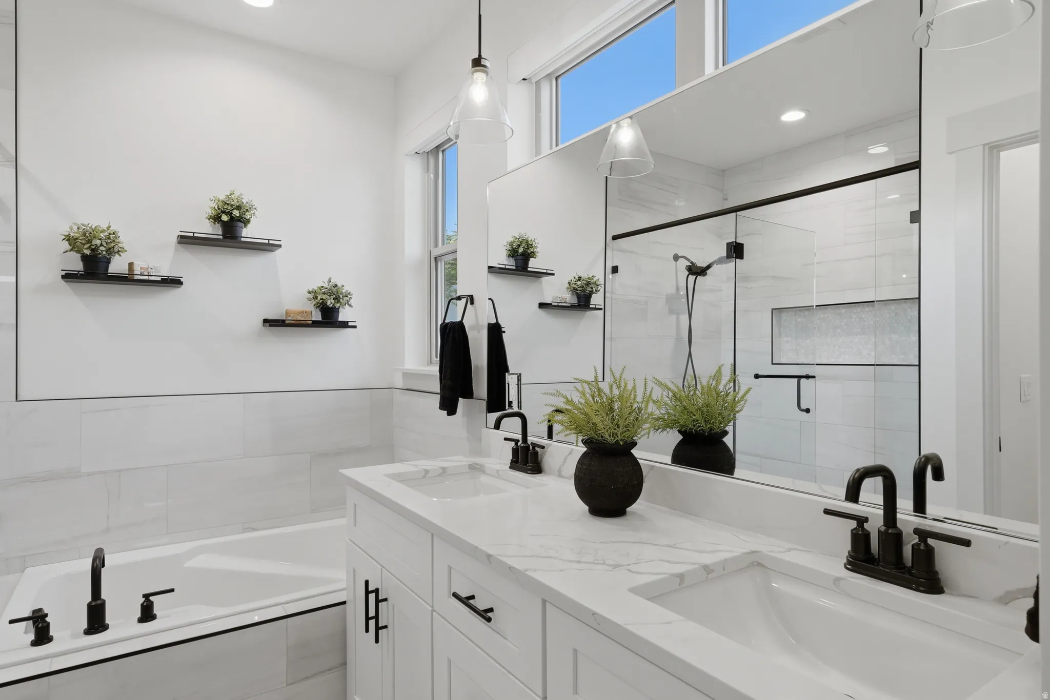 Dual sink vanity with stone-finish countertop, undermount sinks, and matte black fixtures