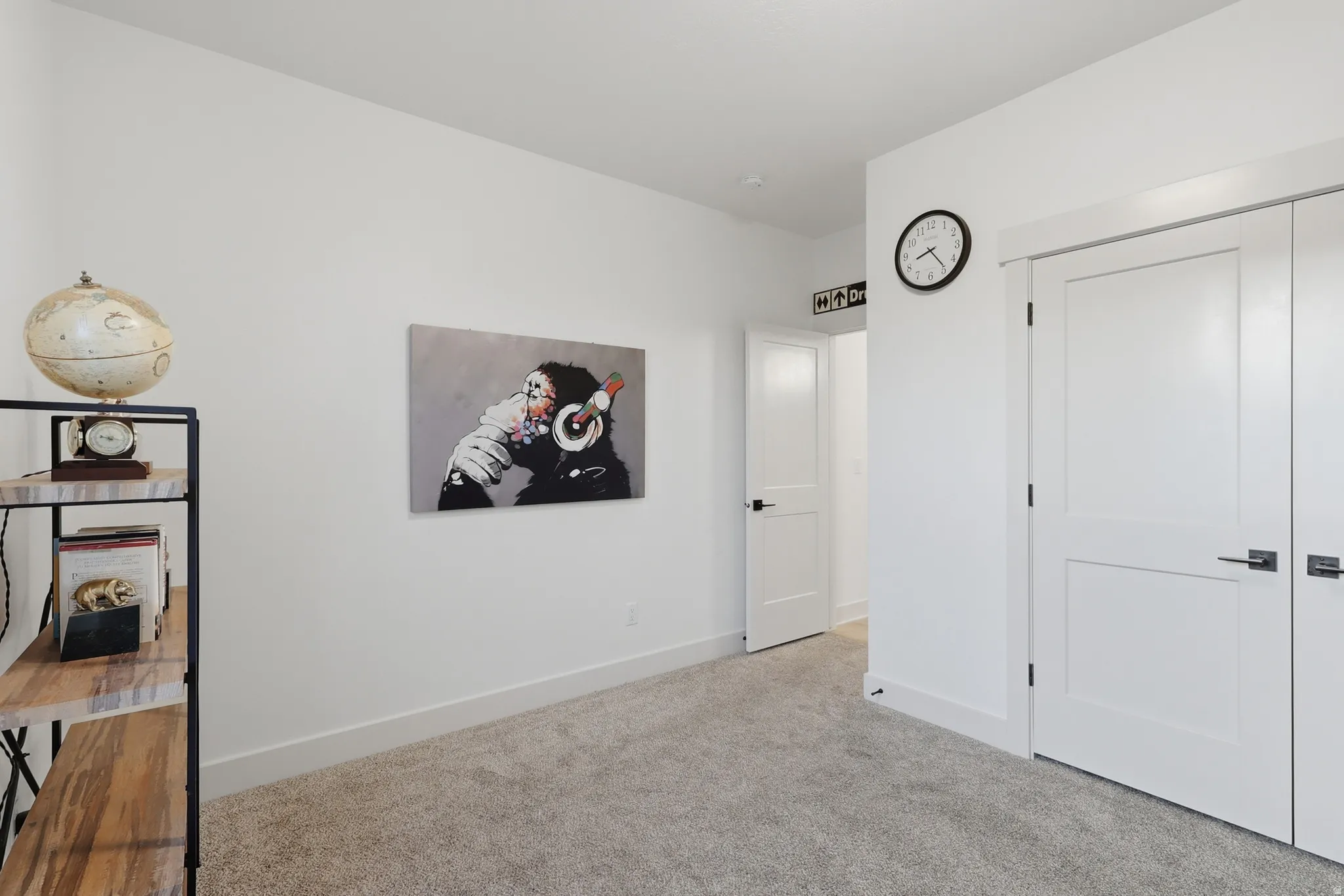 White interior walls with a light-colored carpet flooring