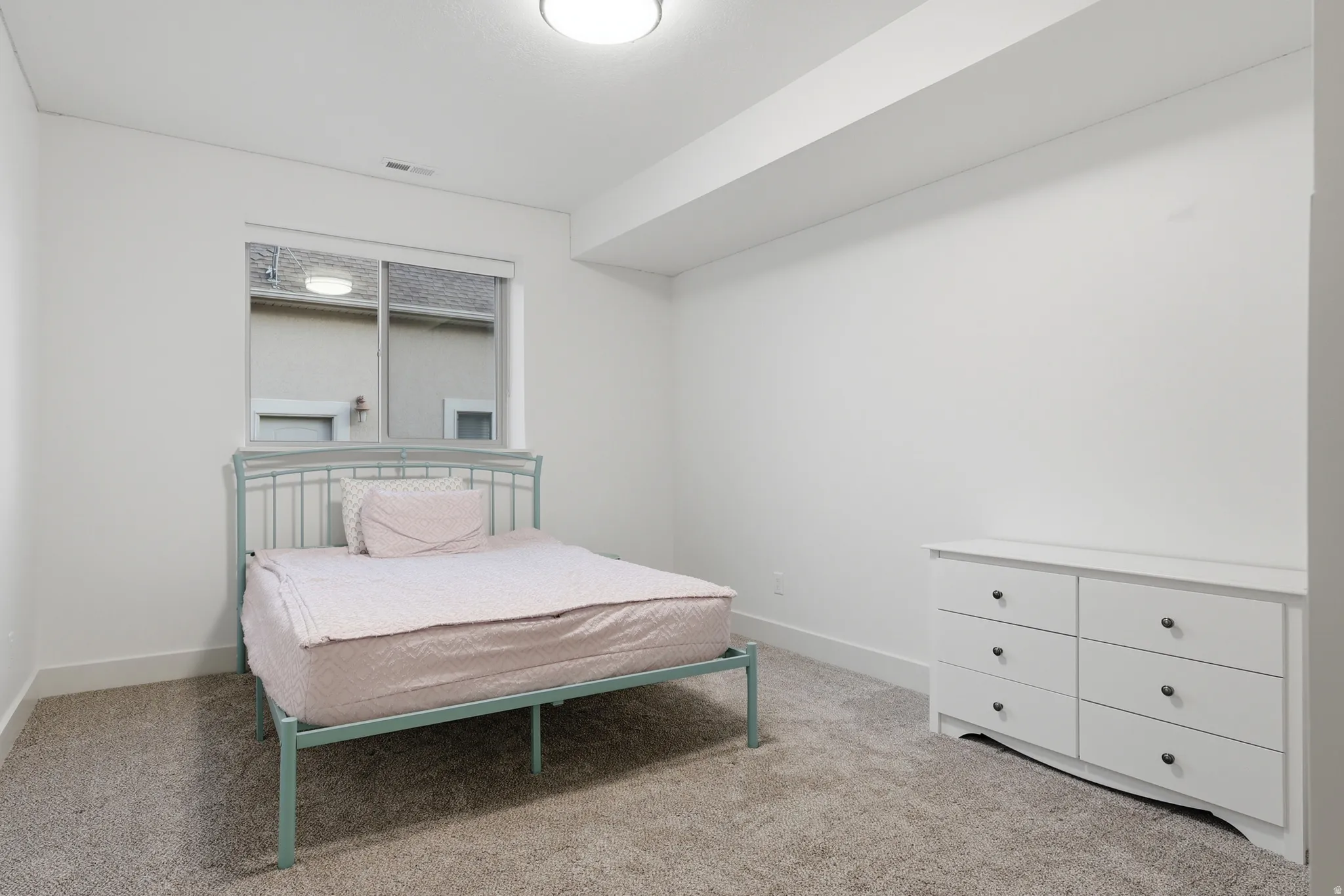 #6 Carpeted room with a ceiling light fixture, white walls, and a single window