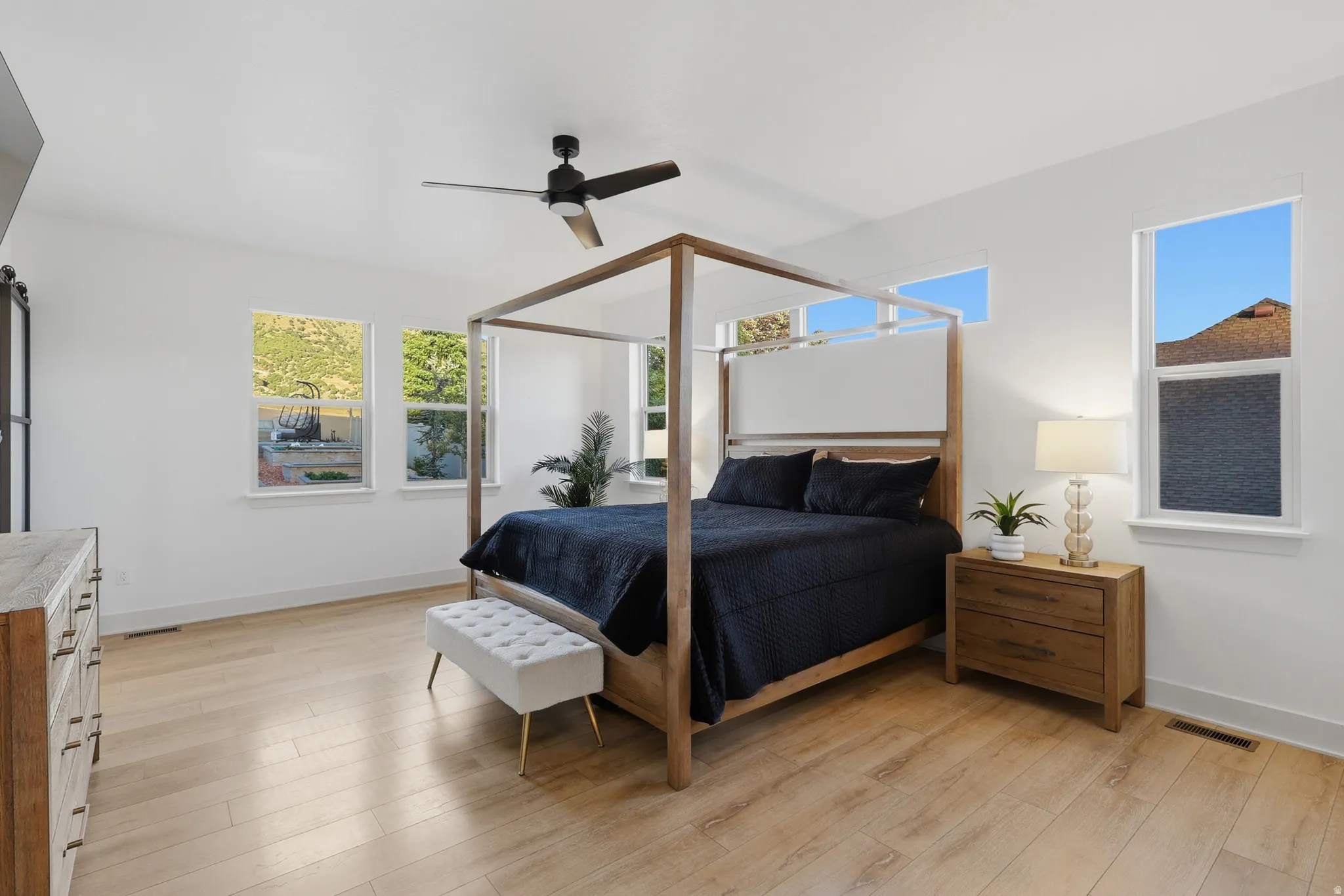 Bright room featuring light wood-finish flooring and white walls