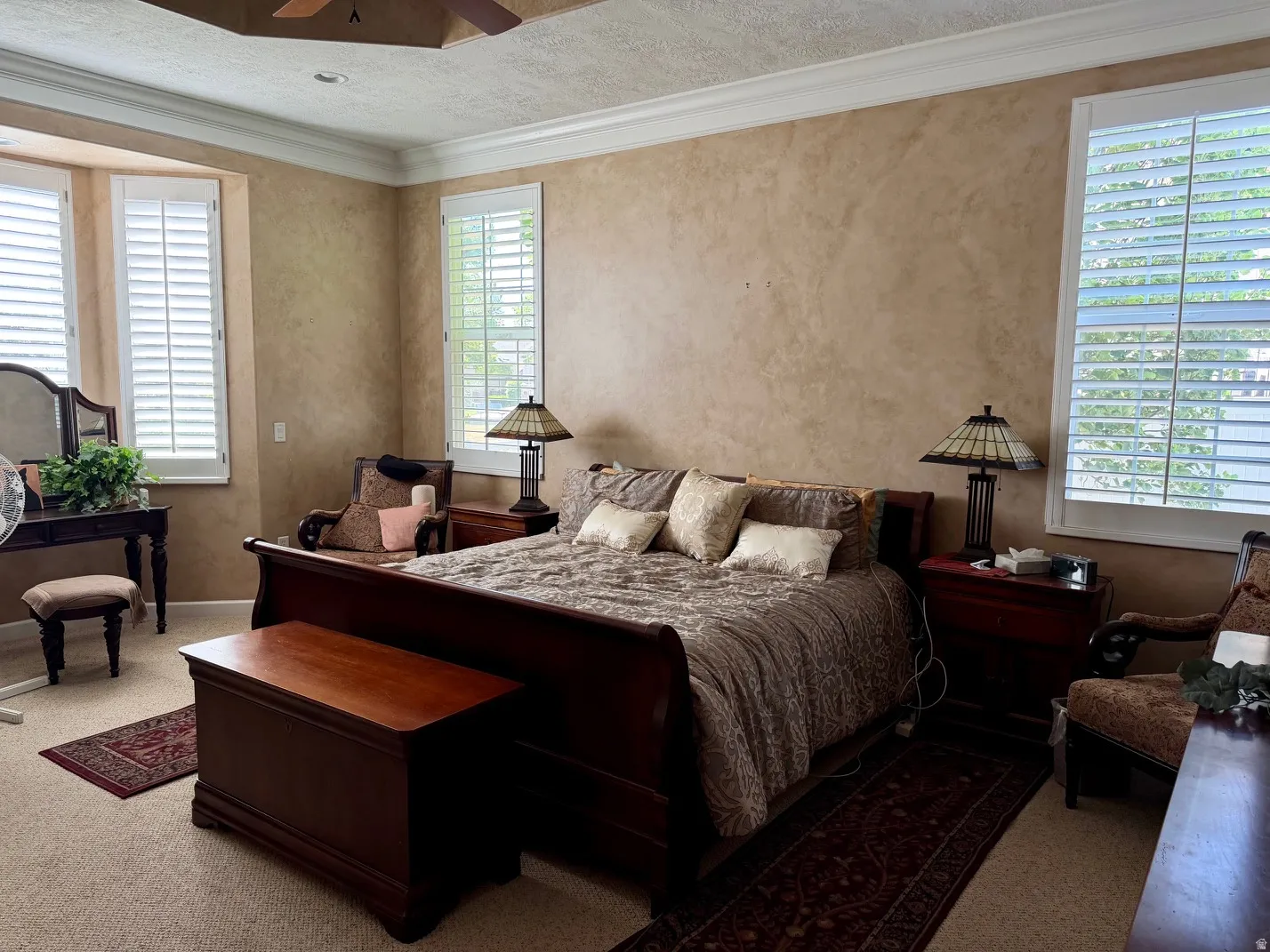 Recessed bed niche with crown molding and plantation shutters