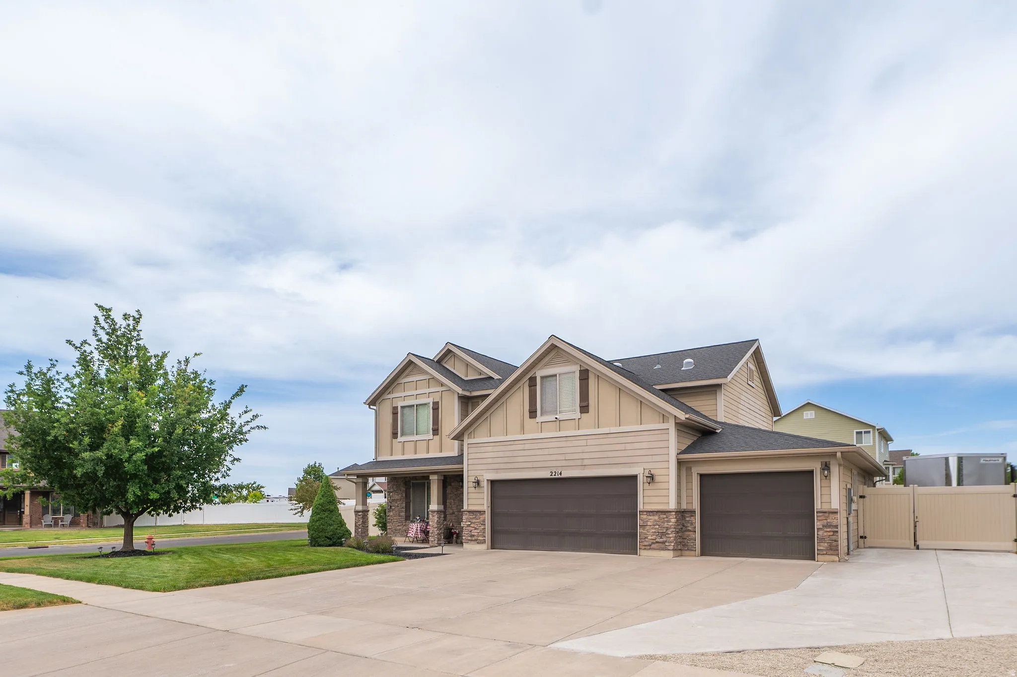 Contemporary two-story residence featuring a combination of horizontal siding and stone veneer