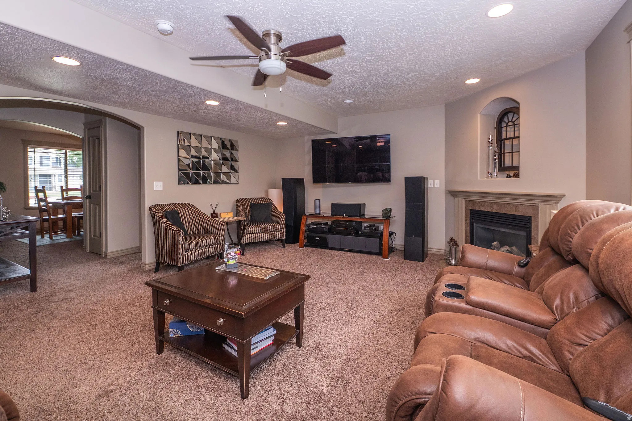 Spacious room with recessed lighting and a ceiling fan