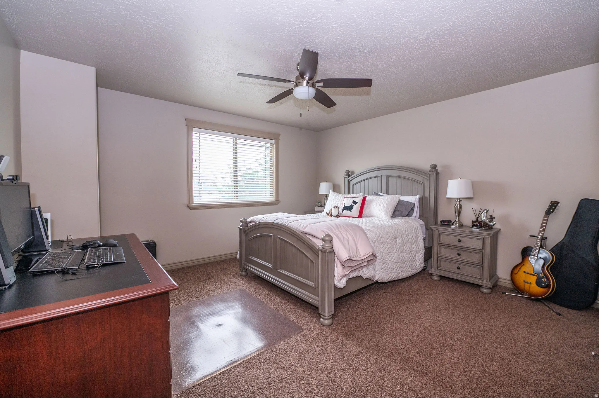 Bedroom featuring a window with blinds, a ceiling fan, and carpeted flooring
