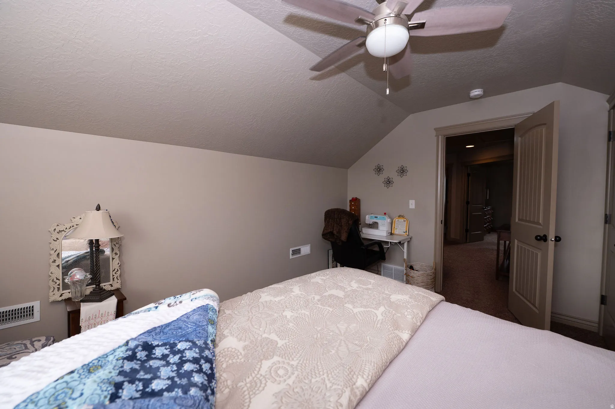 Sloped ceilings featuring a ceiling fan with integrated lighting