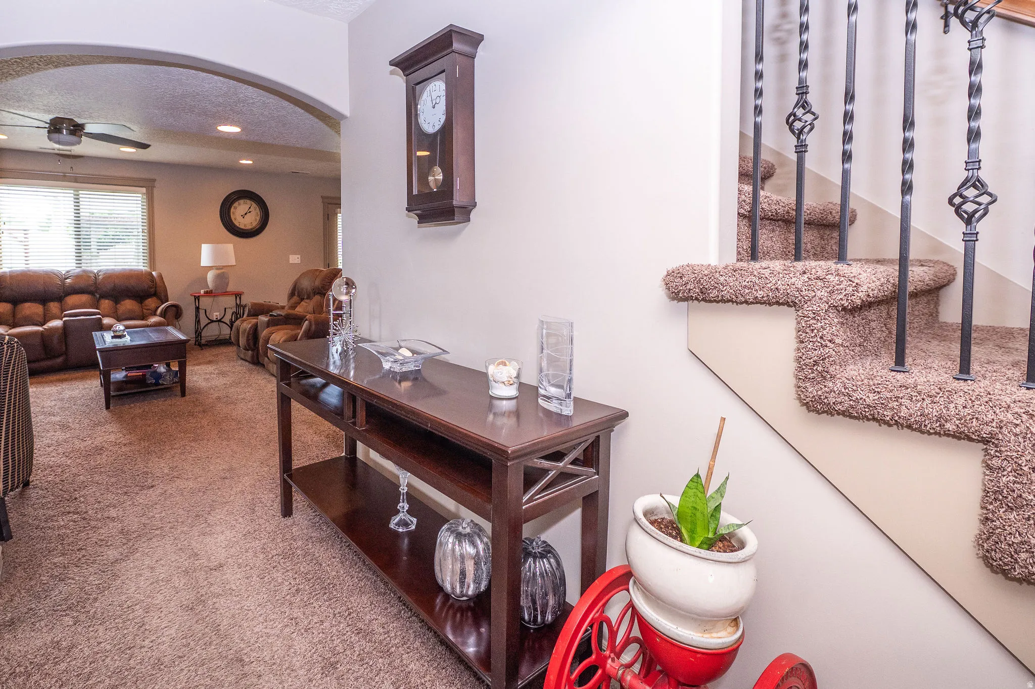 Archway entry to a living area featuring recessed lighting, a ceiling fan, and window blinds