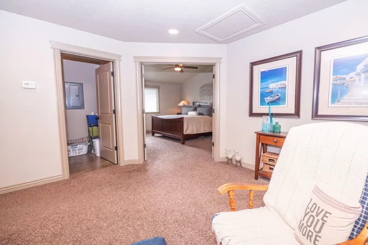 Neutral-toned walls complement the textured brown carpet flooring