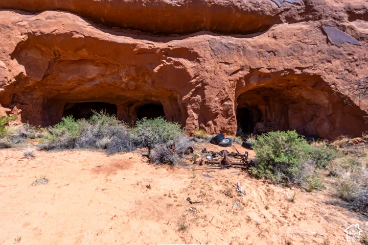 Red rock formation featuring multiple cave entrances