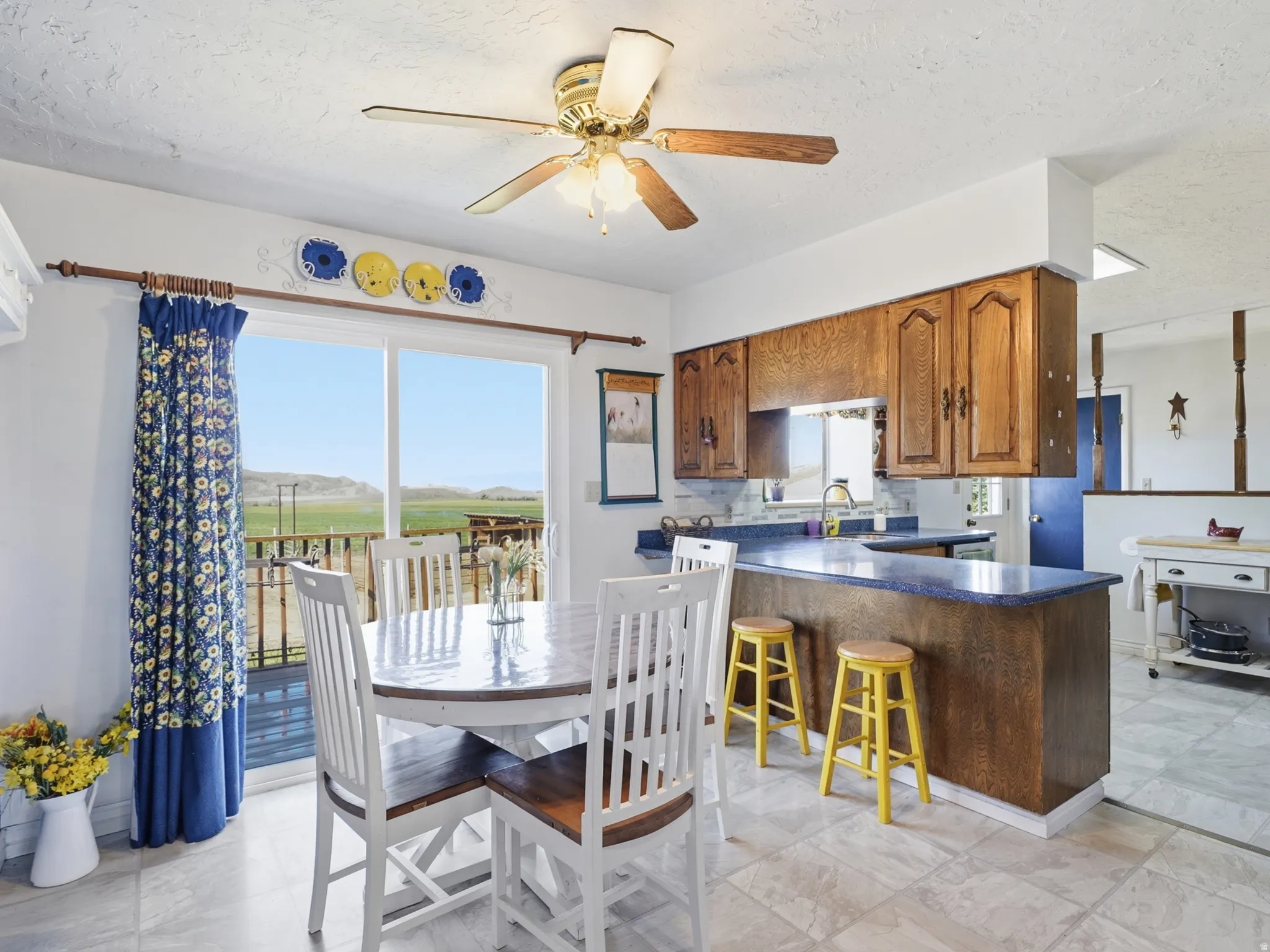 Kitchen dining area featuring wood-finish cabinetry, a breakfast bar with countertop seating, and tile flooring