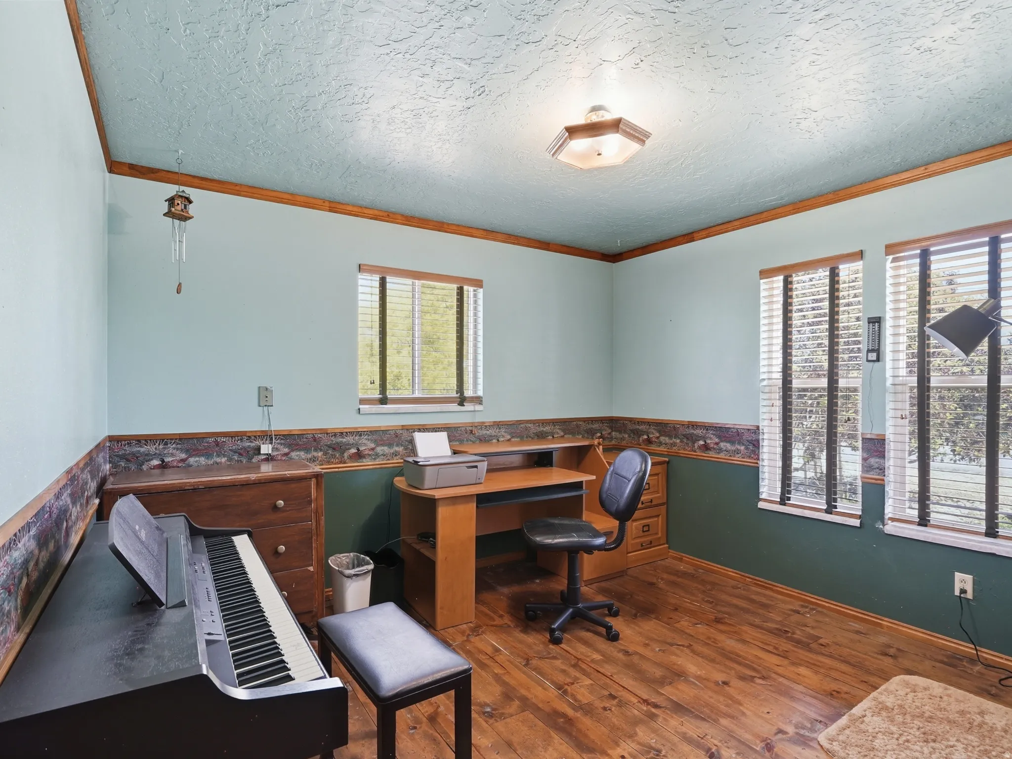 Flexible room with beautiful wood floor and two large windows