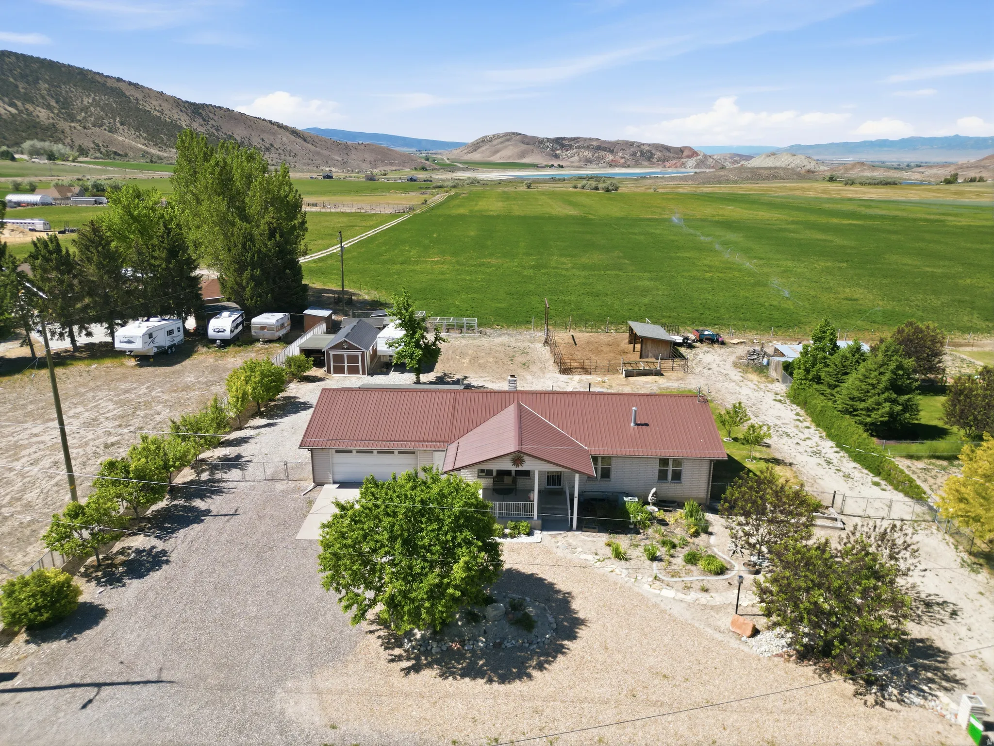 Ranch-style residence featuring a metal roof, attached garage, and a covered front porch