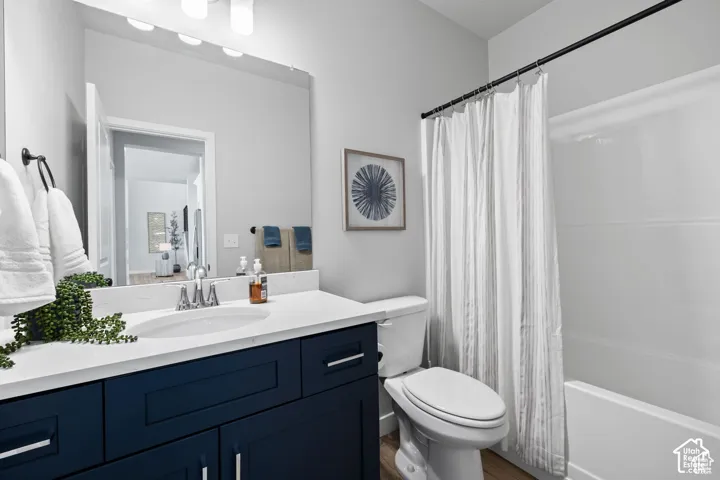 Contemporary bathroom featuring a dark blue vanity with a white countertop, an undermount sink, and a chrome faucet