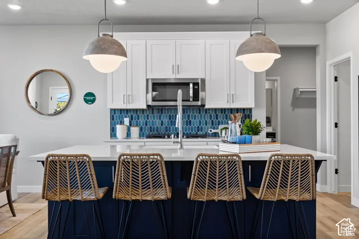 Kitchen island with a white countertop and blue paneled base