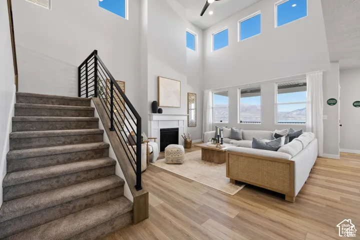 Two-story great room featuring high ceilings and wood-finish flooring