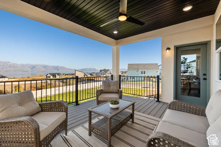 Covered outdoor patio featuring a slatted ceiling with recessed lighting and a ceiling fan