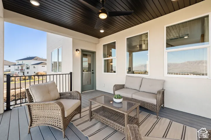 Covered outdoor patio featuring composite decking, recessed lighting, and a ceiling fan