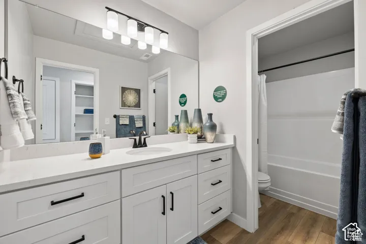 Vanity with a white countertop and rectangular undermount sink, complemented by a matte black faucet