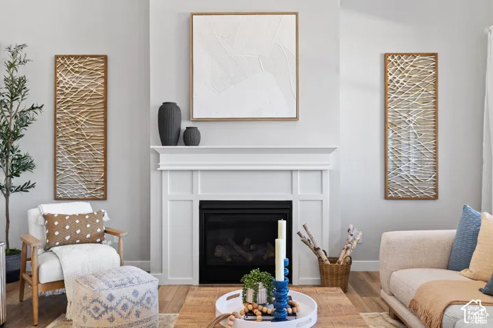 Living area featuring a classic white mantel fireplace with a black firebox