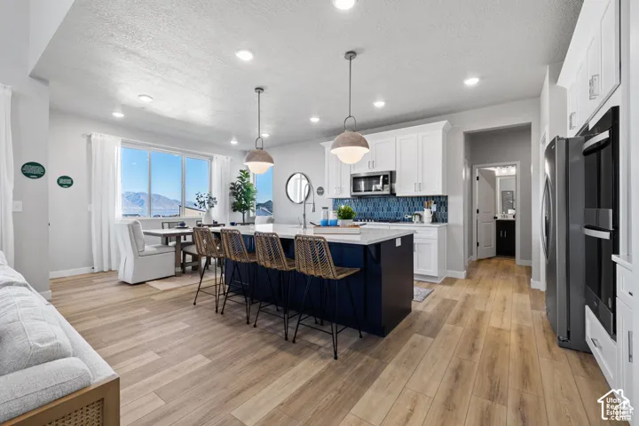 Open concept living area featuring wood-finish flooring