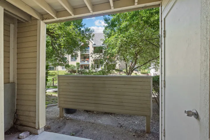 Patio area featuring a privacy fence and concrete flooring