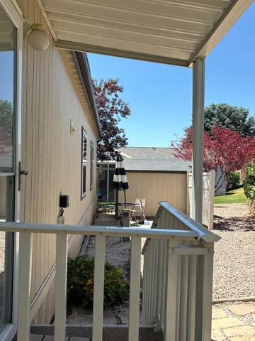 Covered patio featuring a metal awning and white railing
