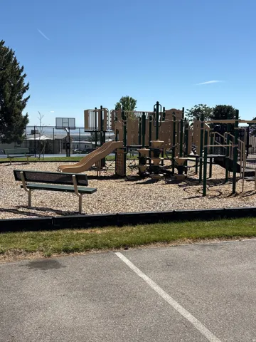 Recreational playground area featuring multi-level structures, slides, and climbing elements