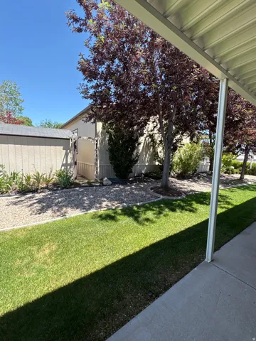 Covered patio area opening onto a manicured lawn