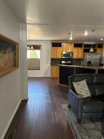 Open-concept living space featuring wood-finish flooring throughout
