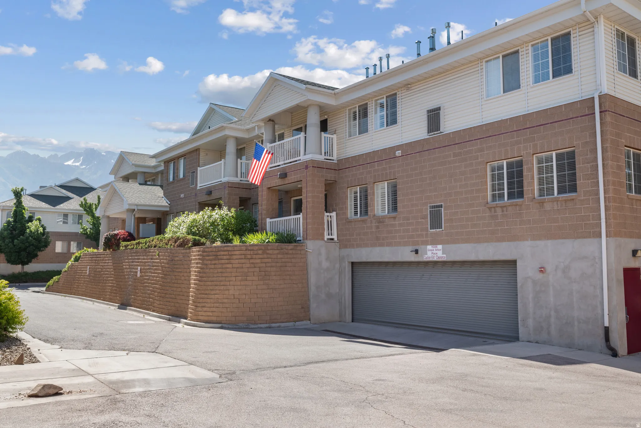 Multi-story residential building featuring brick and siding exterior construction