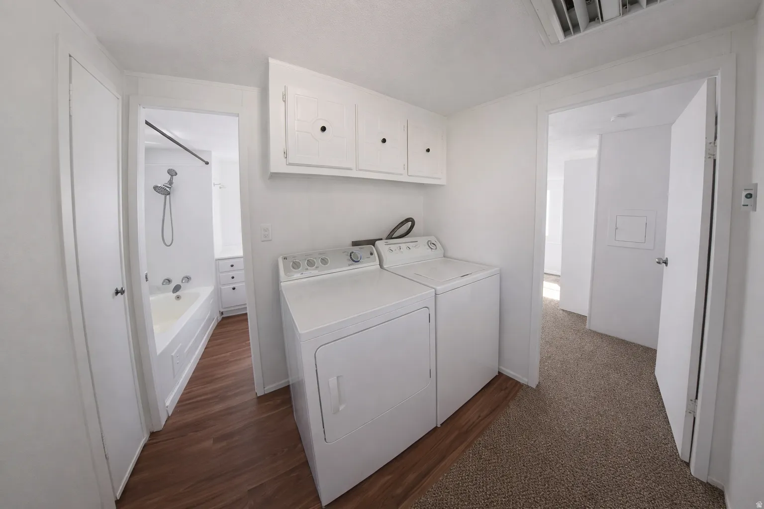 Image from 2 yrs ago before move-in. Dedicated laundry area featuring a washer and dryer, complemented by white upper cabinetry