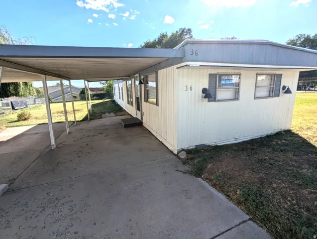 Covered carport with concrete paving