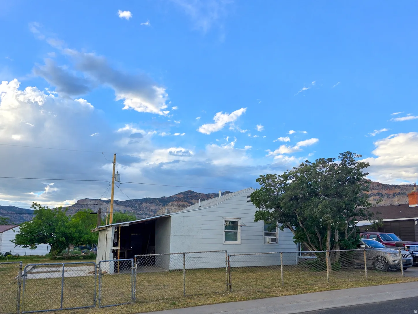 Light blue siding exterior with a pitched roof and visible window unit