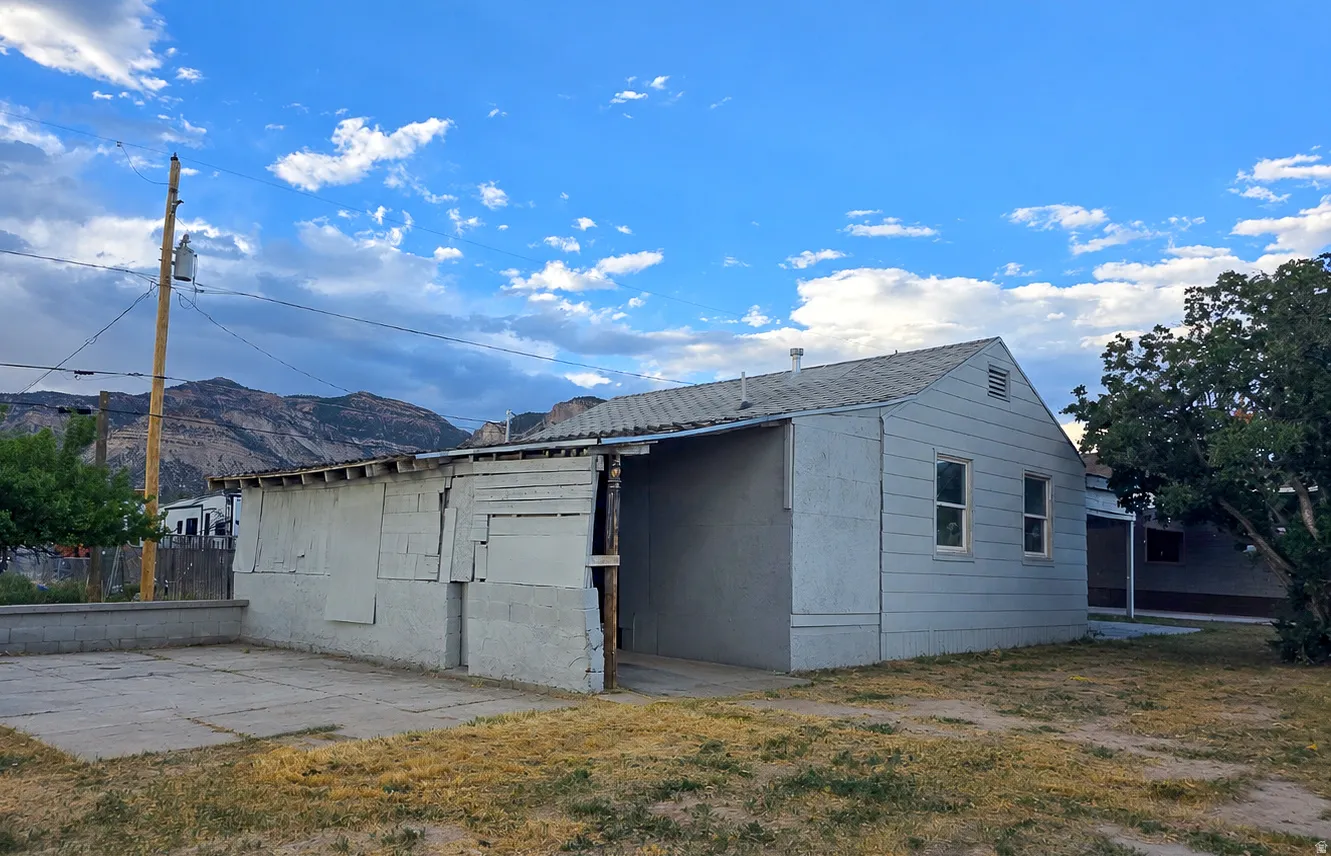 Light blue siding exterior with a pitched roof and multiple windows