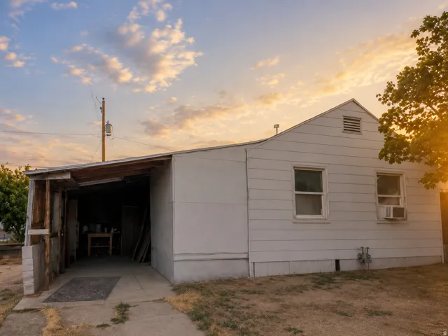 Property exterior featuring white horizontal siding and an attached carport with a concrete floor