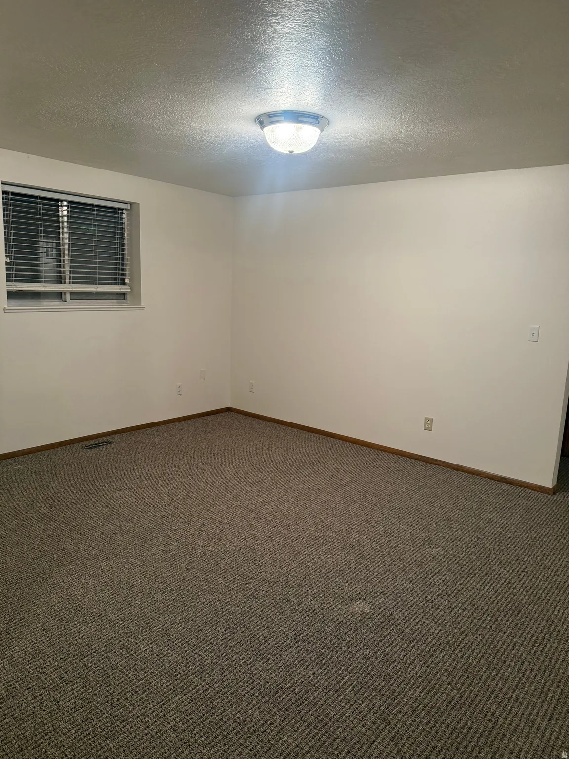 Neutral wall tones complement the neutral-toned carpeting throughout this space