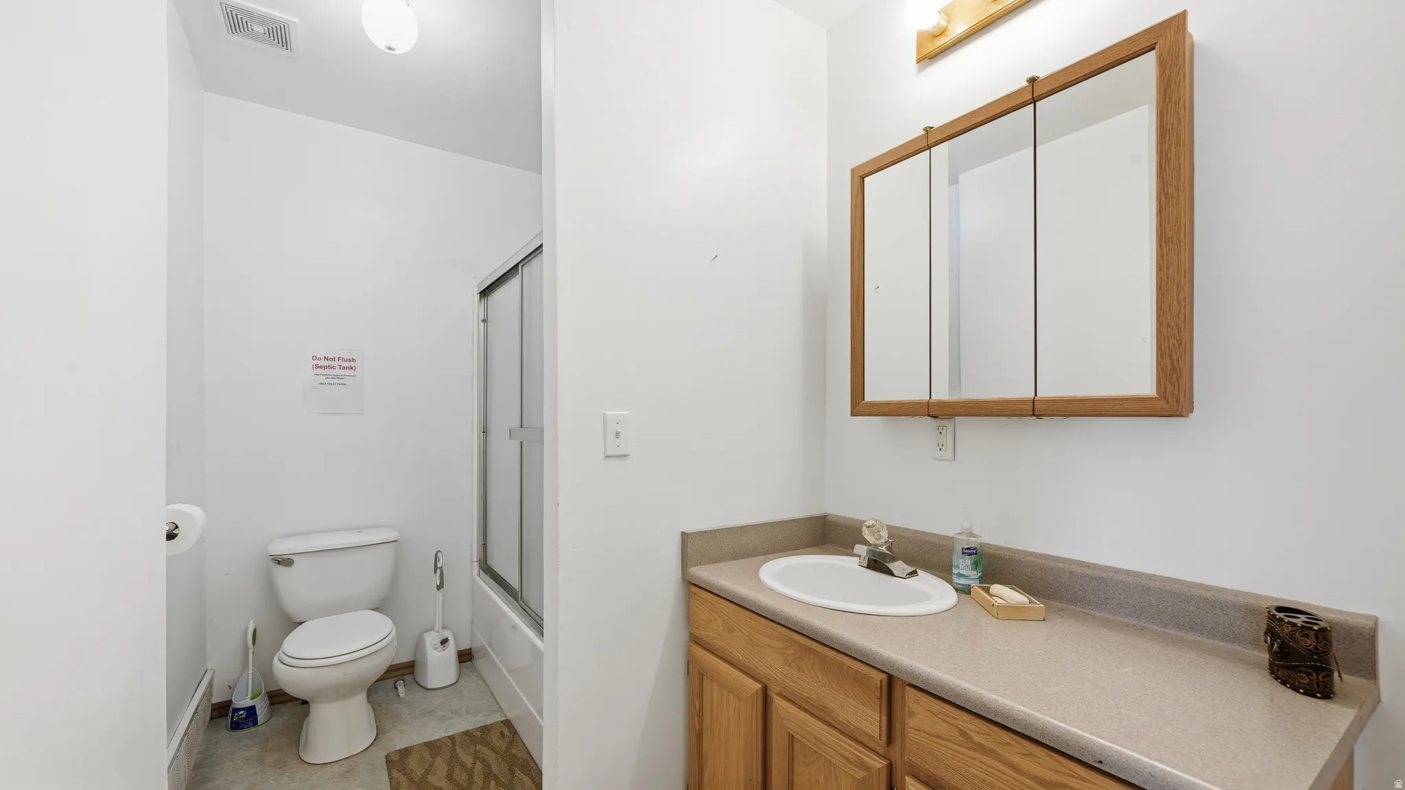 Bathroom vanity featuring a built-in sink and wood-finish cabinetry