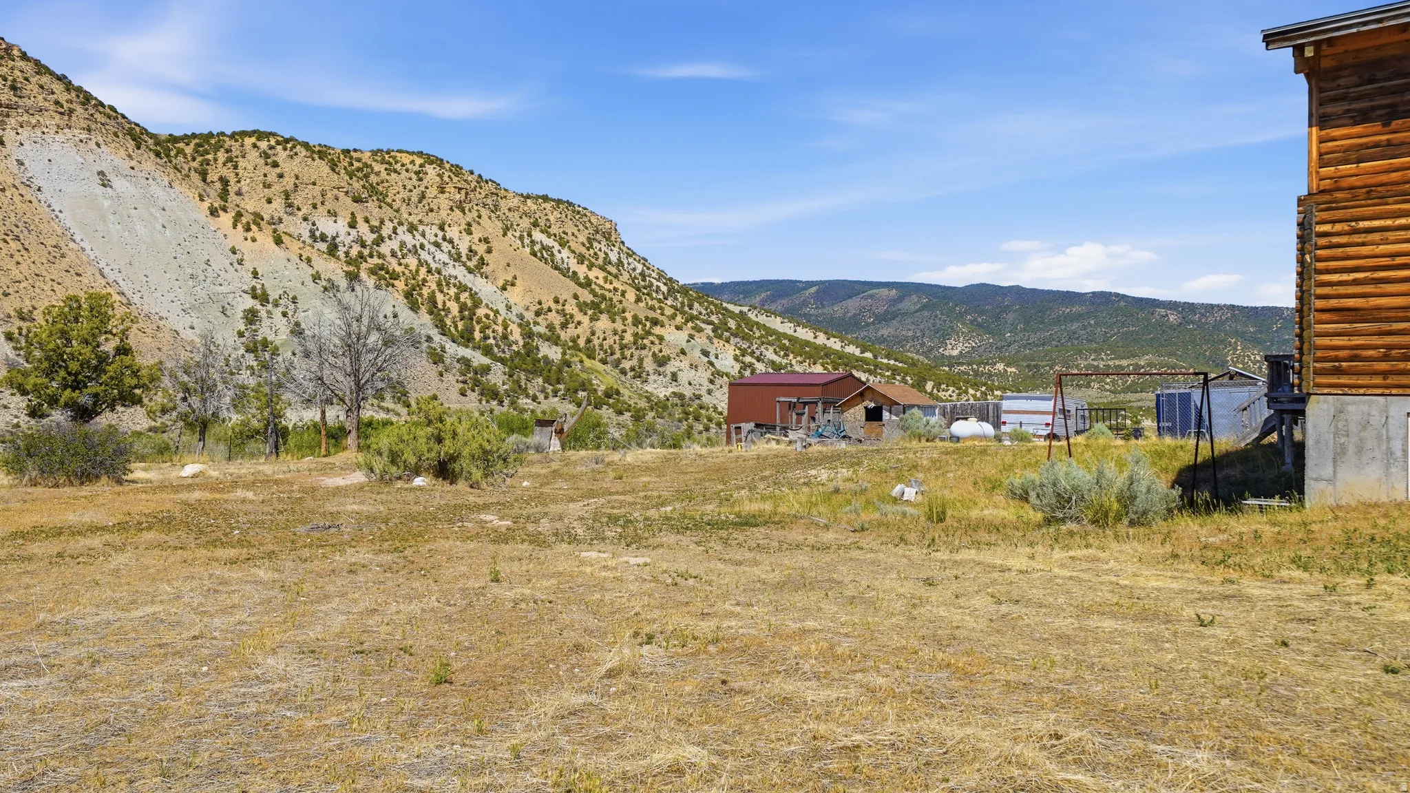 Expansive outdoor space featuring a natural landscape and distant mountainous terrain