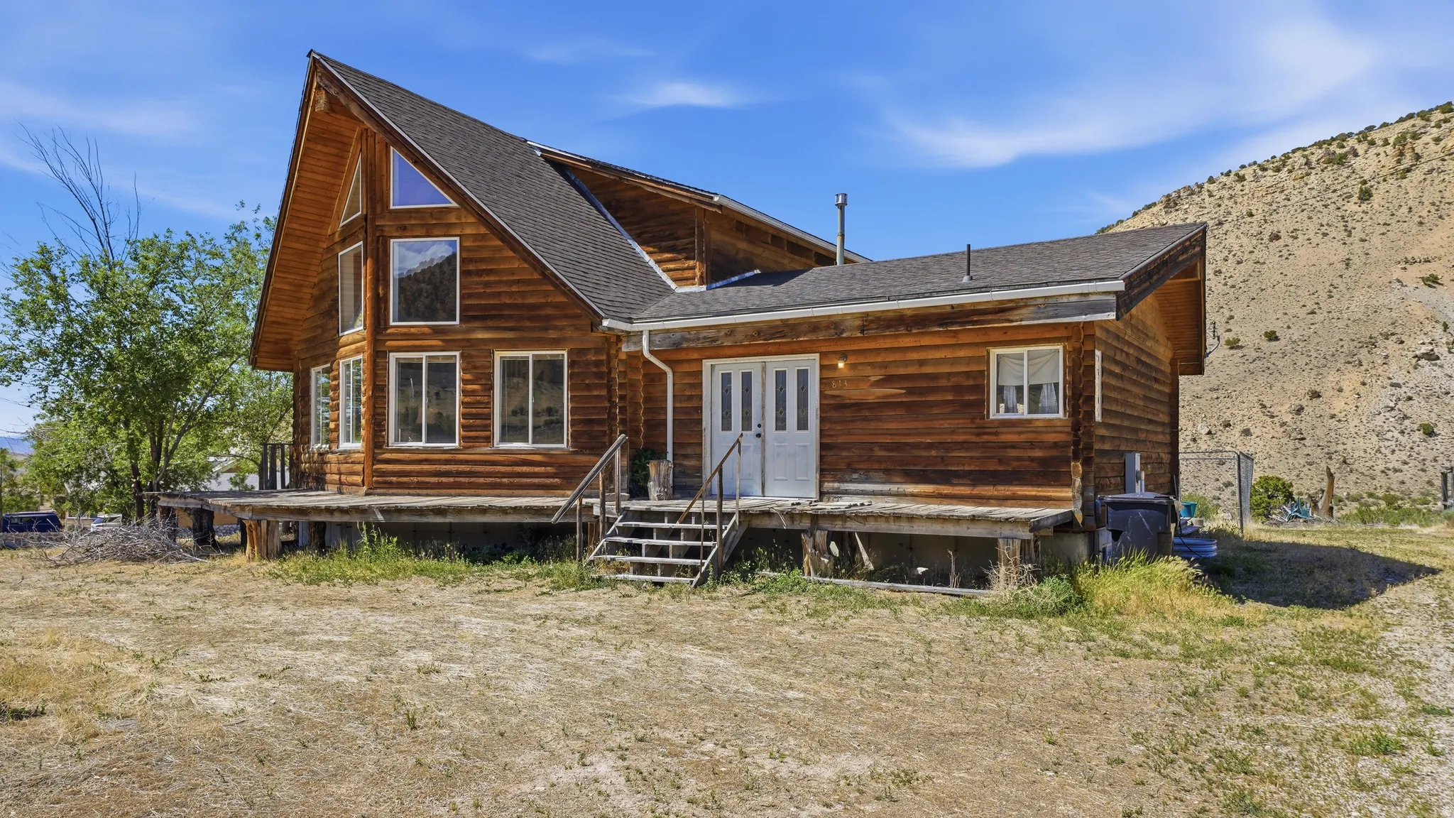 Log cabin-style residence featuring a prominent A-frame architectural element