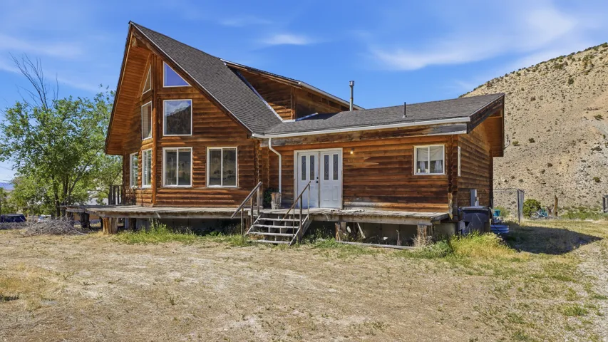 Log cabin-style residence featuring a prominent A-frame architectural element