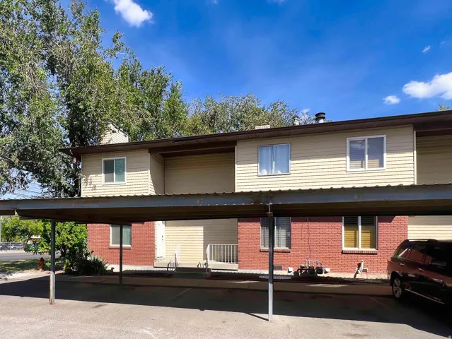 Two-story structure featuring brick and horizontal siding