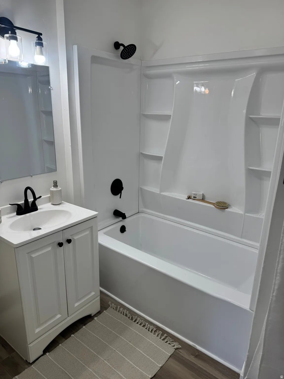 White bathroom vanity with cabinet storage and integrated sink