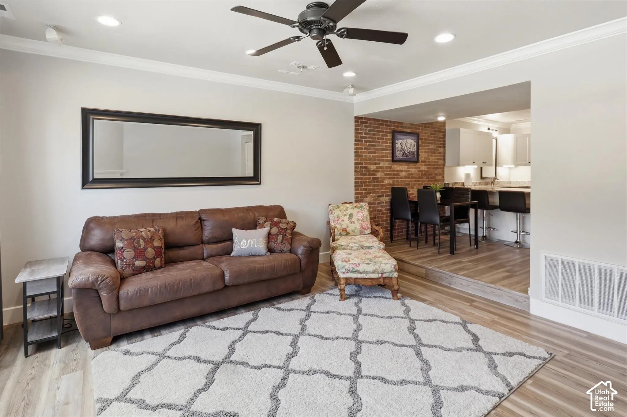 Living area featuring wood-finish flooring, recessed lighting, and a ceiling fan