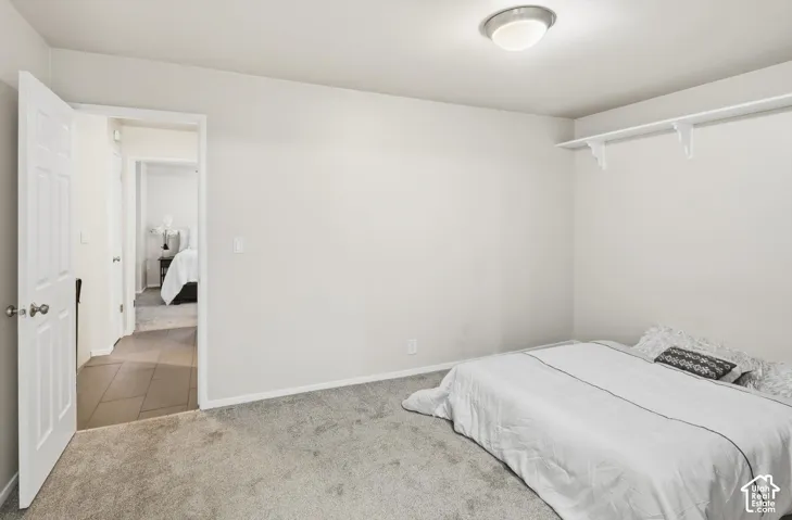 Bedroom featuring light gray carpeting, neutral wall paint, and a semi-flush mount ceiling light