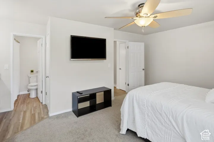 Bedroom featuring light gray wall paint, carpeting, and a ceiling fan with light fixture