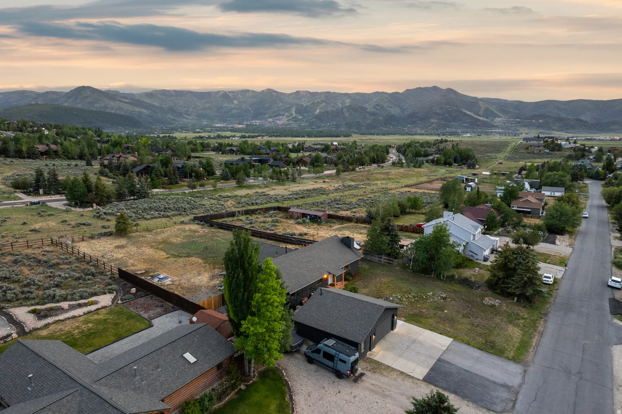 Expansive mountain scenery framing a residential area with varied architectural styles