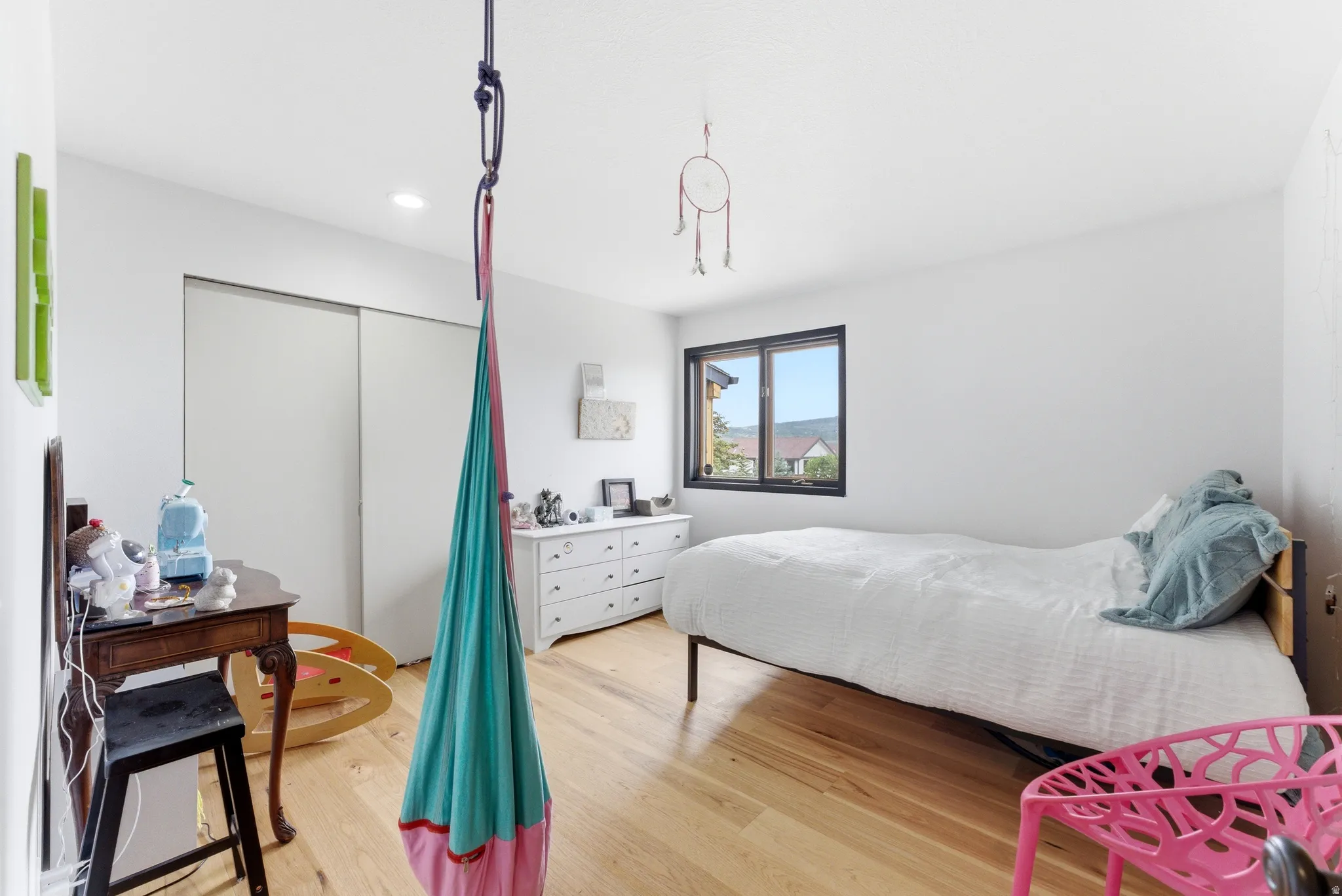 Light wood-finish flooring with white walls and recessed ceiling lighting