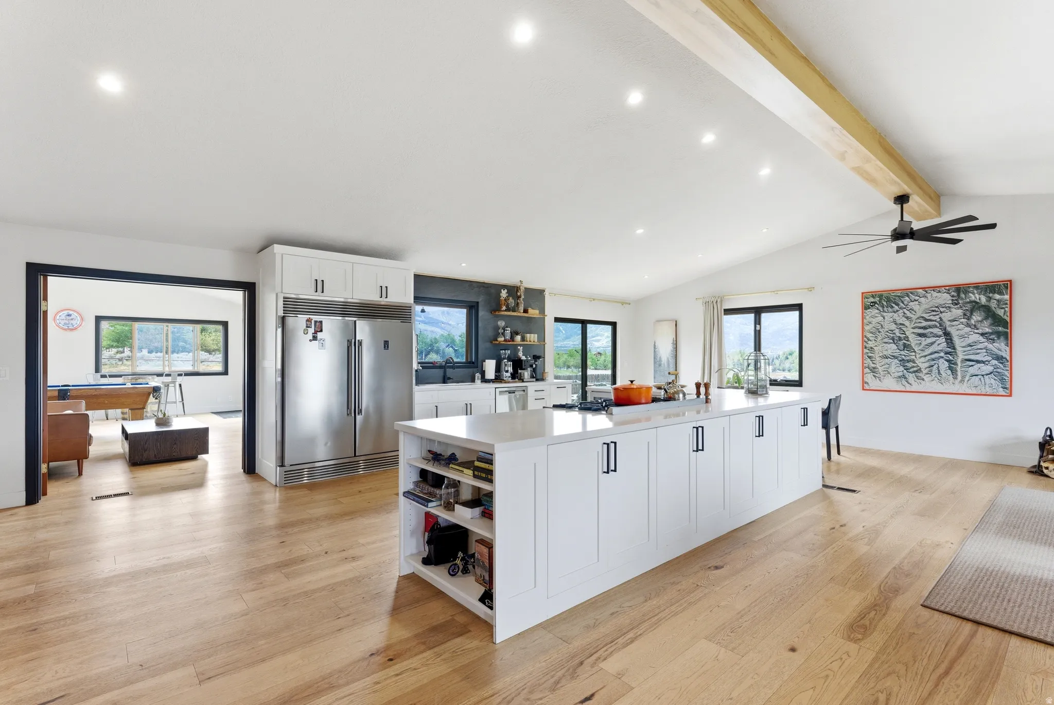 Expansive kitchen featuring a large central island with white cabinetry and a light-toned countertop