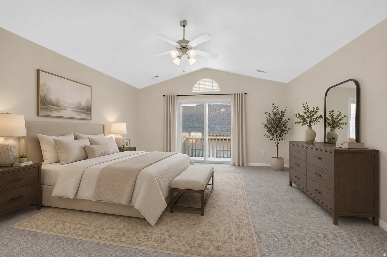 Spacious bedroom featuring vaulted ceilings, ceiling fan with integrated lighting, wood-finish flooring, sliding glass door with transom window, and private balcony